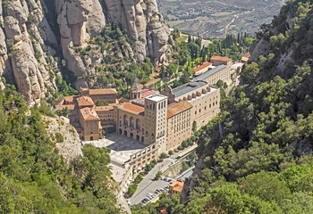 The Benedictine abbey Santa Maria de Montserrat in Monistrol de Montserrat, Spain. It hosts the Virgin of Montserrat, the favourite in Catalonia. - obrazy, fototapety, plakaty