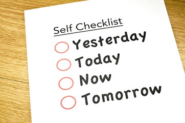 left view self checklist printed on paper and placed on brown wooden floor