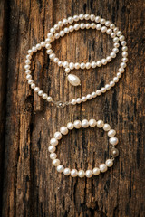 White pearl put on old wooden table.
