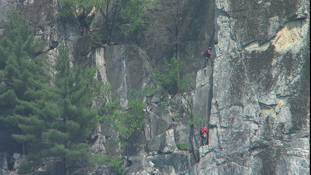 Climber descending Seneca Rock on rope