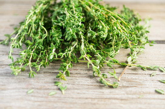 Sprigs of thyme on an old wooden background