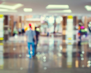 Blurred Background: people go for Shopping Mall along the window