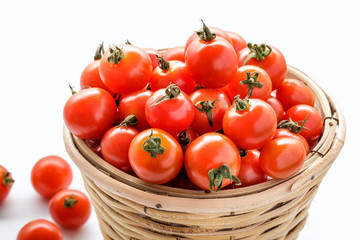 pile of cherry tomatoes in a rattan basket