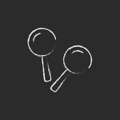 Maracas icon drawn in chalk.