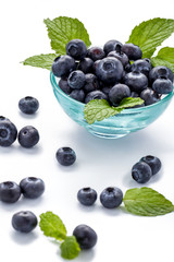 fresh blueberries and mint leaves in a glass bowl