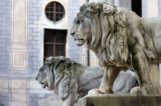 Lion statue. Stone monuments of lions in Odeon square in Munich, Bavaria, Germany.