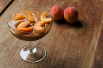 Apricot jam in glass bowl and fresh fruits