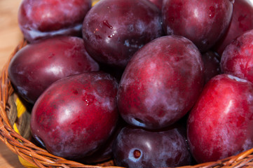 Close view of fresh plums on the wooden board