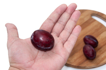 Fresh plums in the hand