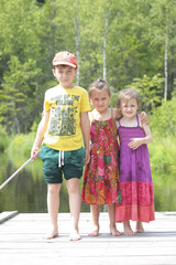 Three happy children on green forest background