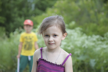 Four year old girl and a boy on forest background