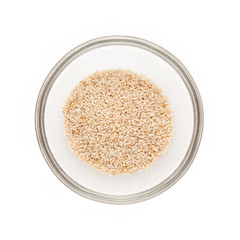 Top view of Organic White Poppy seed (Papaver somniferum) half filled in glass bowl isolated on white background.