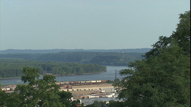 WS pan up river to reveal Illinois/Iowa bridge over Mississippi river