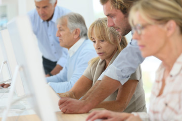 Group of senior people attending computing class