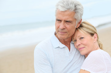 In love senior couple embracing at the beach