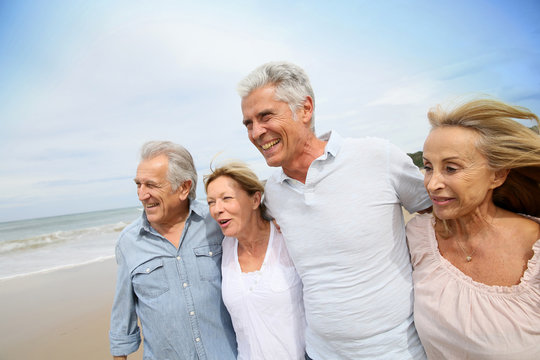 Senior people walking on the beach