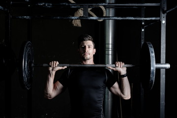 Fototapeta na wymiar Athlete Fitness trainer working out / weight lifting in a gym