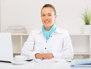 Smiling businesswoman waiting for clients.