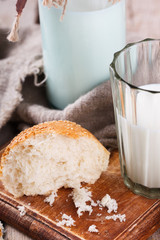 Sesame seed bun and a glass of milk.