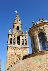 Fototapeta na wymiar Giralda tower and lantern of Sagrario chapel, Cathedral of Seville, Andalusia, Spain