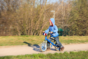 little boy on running bike outdoors, kids sport