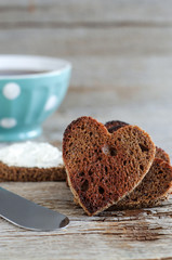 Heart shaped rye toasts and cup of coffee