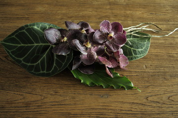A group of purple orchids bouquet on the wooden background