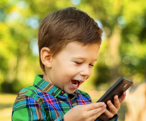Laughing boy using smartphone