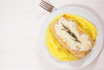fish fillet under cheese with mashed potatoes