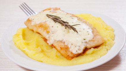 fish fillet under cheese with mashed potatoes
