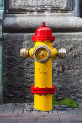 A closeup to a red and yellow fire hydrant in Reykjavik downtown