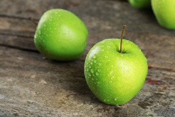 Ripe green apples on wooden table close up