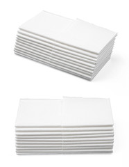 Stack of folded disposable paper tissues on white background