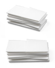 Stack of folded disposable paper tissues on white background