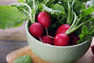 Fresh red radish on wooden table, closeup
