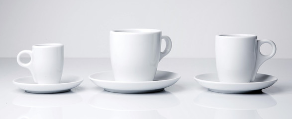 Fototapeta na wymiar White coffee or tea cups on white background