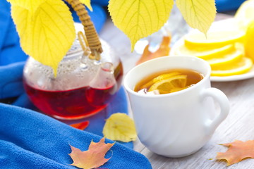 Cup of hot tea with lemon at autumn day