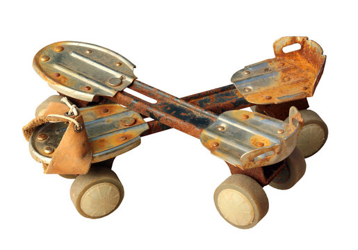 Old rusty metal roller skates, isolated on white