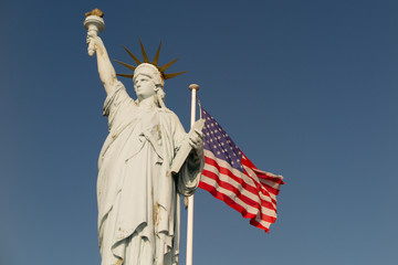 Statue of Liberty with the U.S. flag in the background.