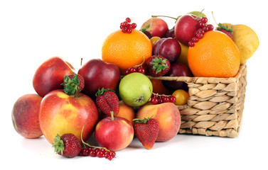 Heap of fresh fruits and berries in basket isolated on white