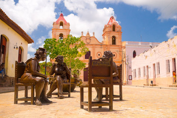 CAMAGUEY, CUBA - SEPTEMBER 4, 2015: Statues, artist Martha Jimenez in front of the Carmen church