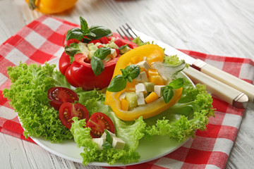 Fresh green salad in pepper on table close up