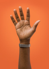  Raised Female Hand Wearing Ring Isolated on Orange