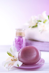 Spa treatment and flowers on wooden table, on light background