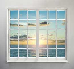 Modern residential window with sea view during sunset