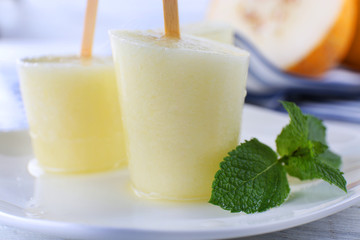 Melon ice lolly on table, closeup