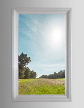 Fototapeta Residential window and trees and sky behind