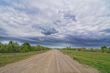 Country road with cloudy sky