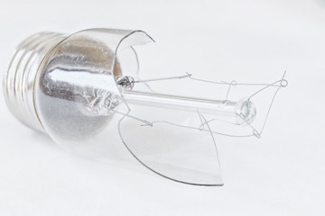 horizontal image of a broken light bulb isolated on white background.