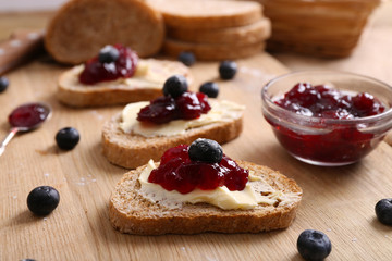 Fresh toast with butter and jam on table close up